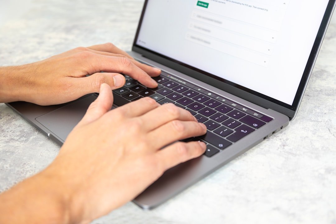 student typing laptop writing essay