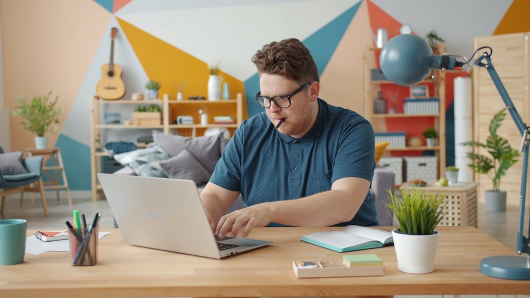 student writing desk laptop