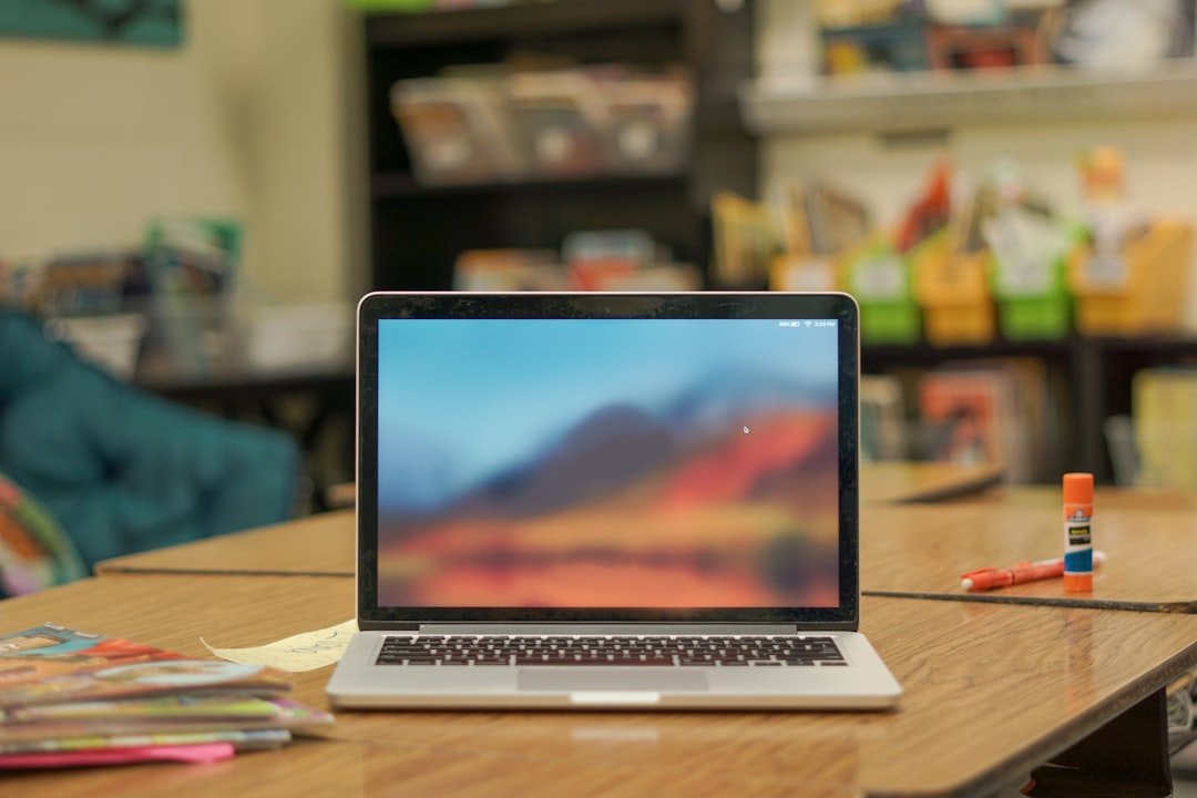 student writing desk laptop