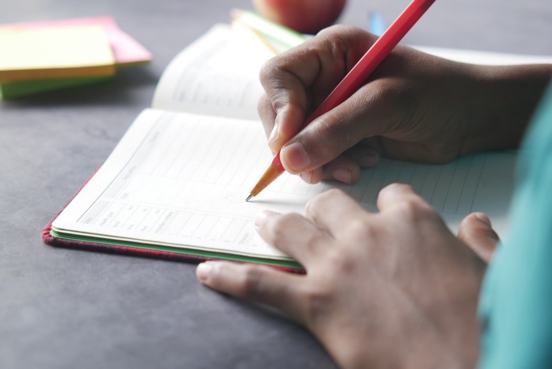 student writing desk notebook