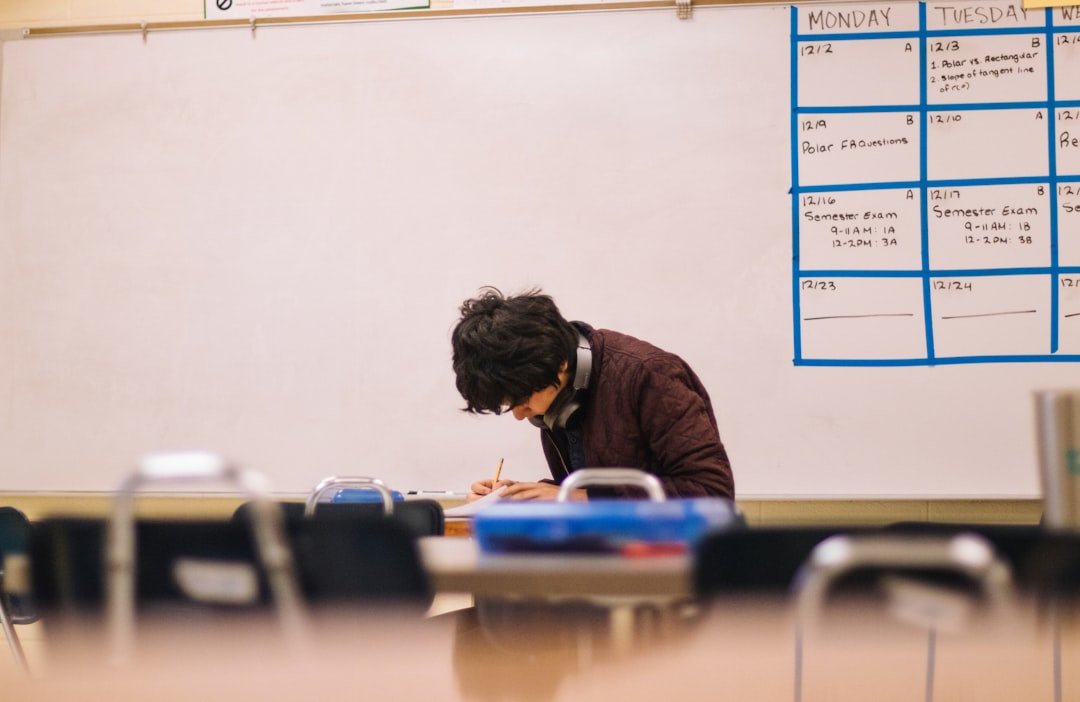 student writing at desk