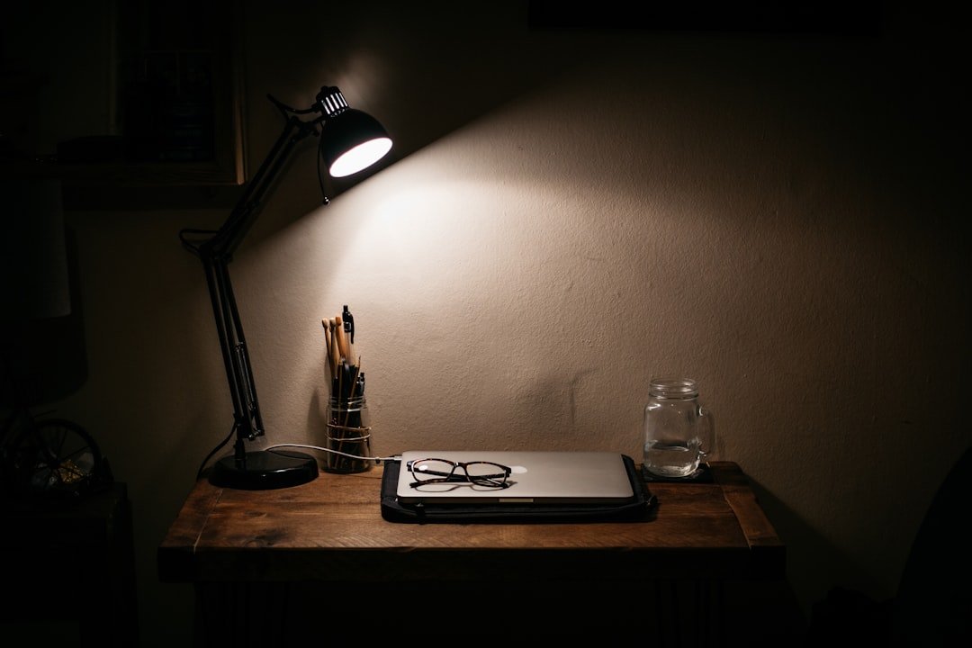 student studying desk lamp