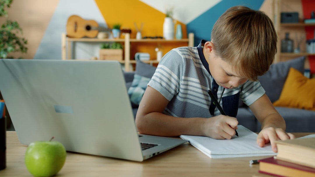 student writing notebook pen desk