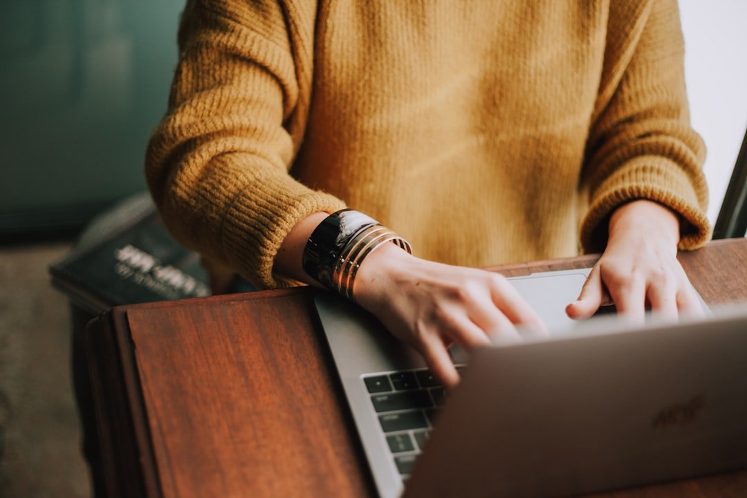student revising essay laptop
