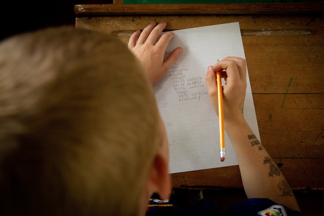 student writing letter desk