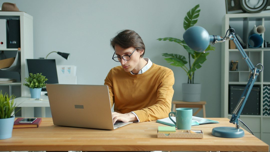 student writing desk laptop