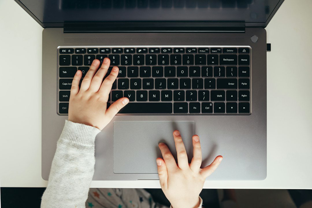 student typing laptop computer